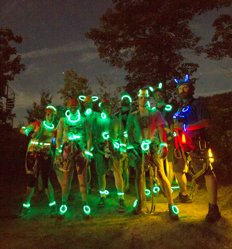 Night zip rideres with colorful glow sticks