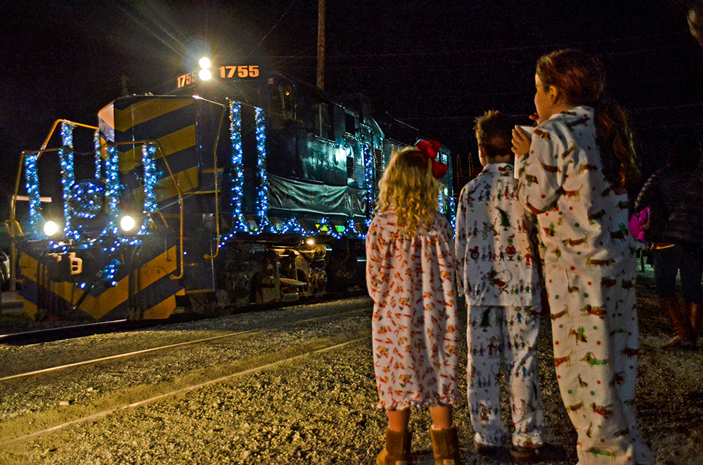 Kids in pajamas at train engine